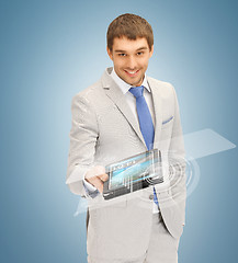 Image showing businessman with tablet pc and virtual screen