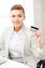 Image showing businesswoman with laptop showing credit card