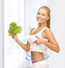 Image showing sporty woman with lettuce showing abs