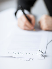 Image showing man hands with gambling dices signing contract