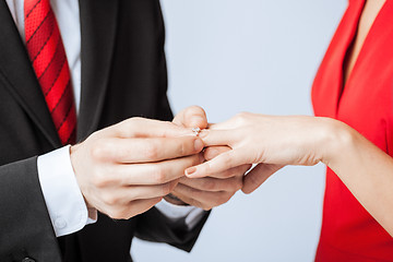 Image showing man putting  wedding ring on woman hand