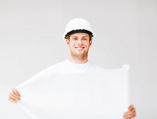 Image showing male architect in helmet with blueprint