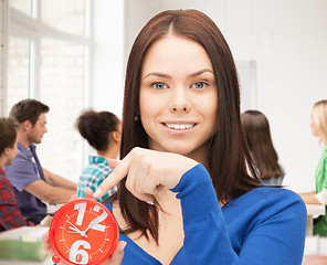 Image showing girl holding big clock at school