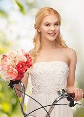 Image showing country girl with bicycle and flowers