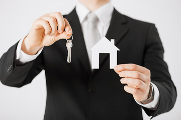 Image showing man holding house keys and paper house