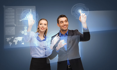 Image showing two business people working with virtual screen