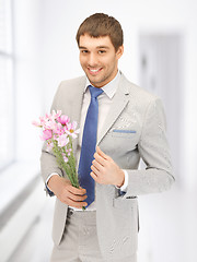 Image showing handsome man with flowers in hand