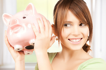 Image showing lovely girl with big piggy bank