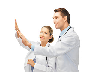 Image showing young doctors working with something imaginary