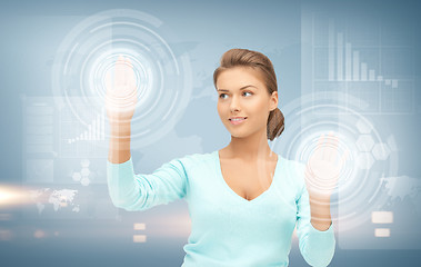 Image showing businesswoman working with virtual screens