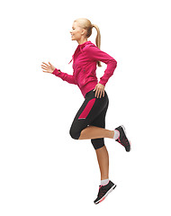 Image showing sporty woman running or jumping