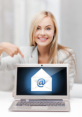 Image showing woman with laptop pointing at email sign