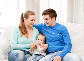 Image showing family and adorable baby with feeding-bottle