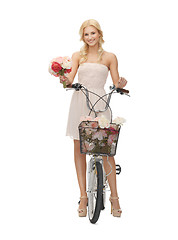 Image showing country girl with bicycle and flowers