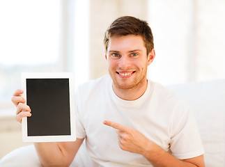 Image showing man pointing at tablet pc at home