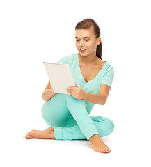 Image showing girl sitting on the floor with tablet pc