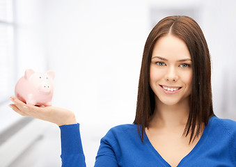 Image showing lovely woman with piggy bank