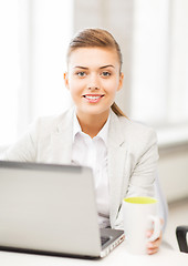 Image showing businesswoman with laptop in office