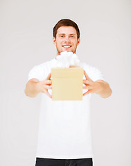 Image showing man in white t-shirt with gift box