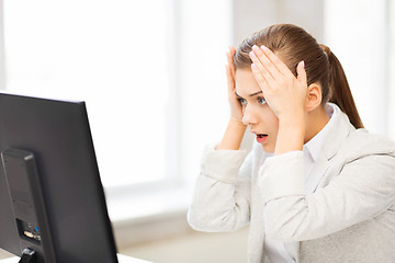 Image showing stressed student with computer in office