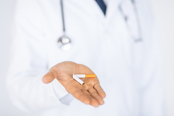 Image showing man breaking the cigarette with hands