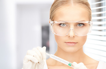 Image showing attractive female doctor with thermometer