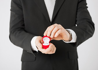 Image showing man with gift box and wedding ring