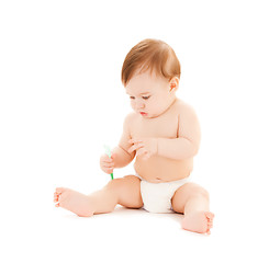 Image showing curious baby brushing teeth