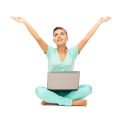 Image showing happy girl sitting on the floor with laptop