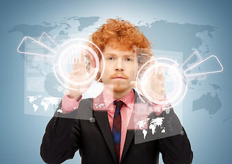 Image showing businessman touching virtual screen