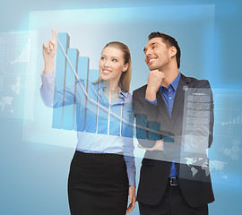 Image showing two business people working with virtual screen