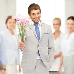 Image showing handsome man with flowers in hand