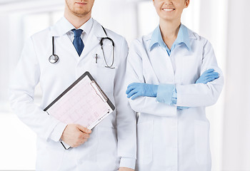 Image showing nurse and male doctor holding cardiogram