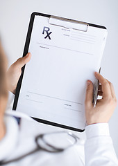 Image showing male doctor writing prescription paper