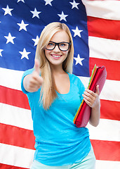 Image showing smiling student with folders