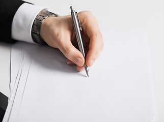 Image showing businessman writing something on the paper