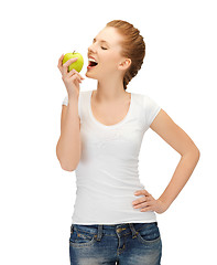 Image showing woman in blank t-shirt eating green apple