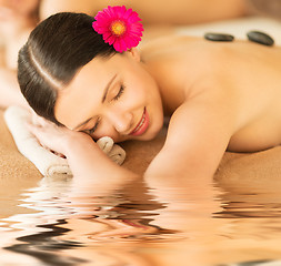 Image showing woman in spa with hot stones