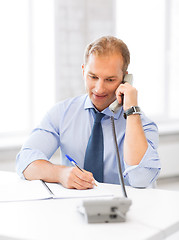 Image showing handsome businessman talking on the phone