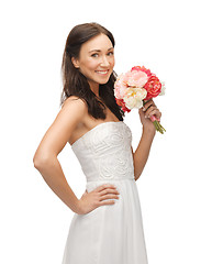 Image showing woman smelling bouquet of flowers