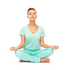 Image showing girl sitting in lotus position and meditating