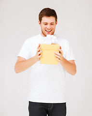 Image showing man in white t-shirt with gift box