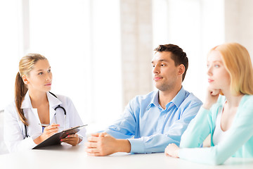 Image showing doctor with patients in cabinet