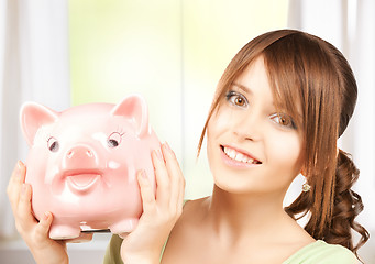 Image showing lovely girl with big piggy bank