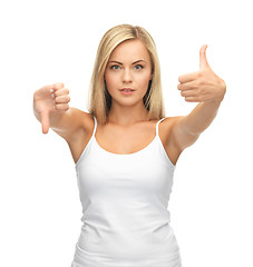 Image showing woman with thumbs up and down