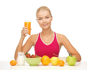 Image showing young woman eating healthy breakfast