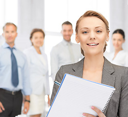 Image showing happy woman with big notepad