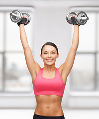 Image showing woman with heavy steel dumbbells