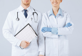 Image showing nurse and male doctor holding cardiogram