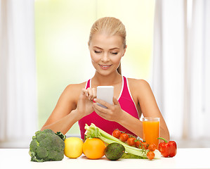 Image showing woman with fruits, vegetables and smartphone